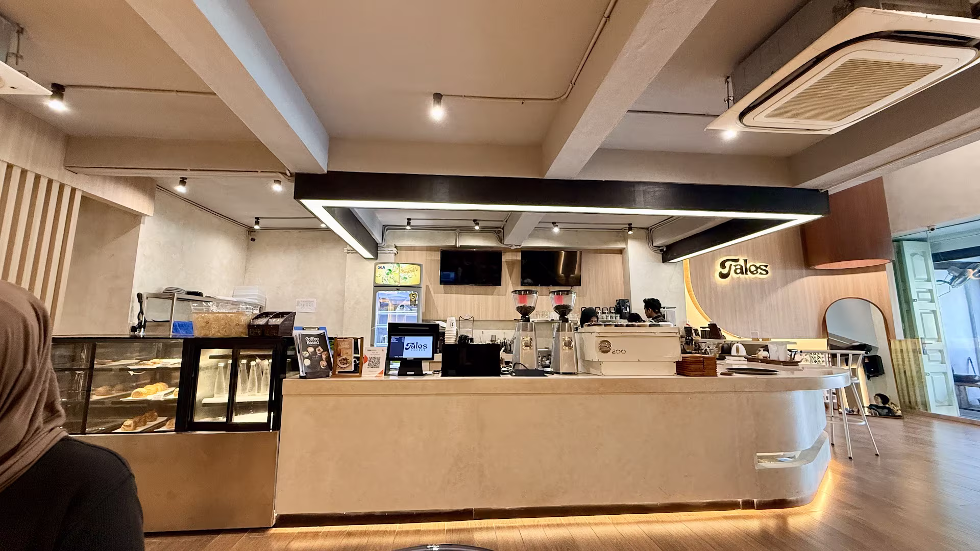 Wide view of the Tales Coffee bar counter and pastry display